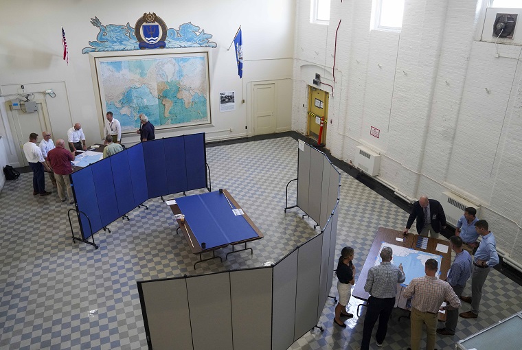 Several people around several maps